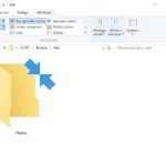 Icône Windows 10 affichant deux flèches bleues sur un dossier compressé